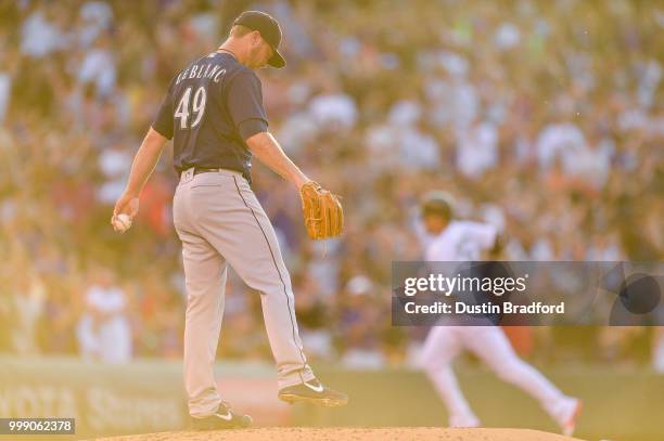 Wade LeBlanc of the Seattle Mariners reacts after allowing a second inning 2-run homerun to Carlos Gonzalez of the Colorado Rockies at Coors Field on...