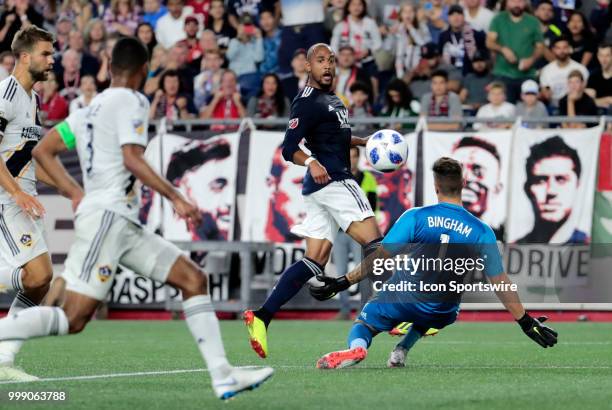 New England Revolution midfielder Teal Bunbury watches his shot beat Los Angeles Galaxy goalkeeper David Bingham but not Los Angeles Galaxy defender...