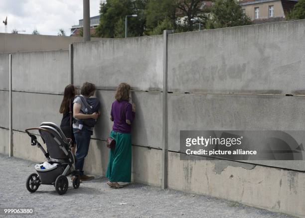 Visitors at the Berlin Wall Memorial in Bernauer Street in Berlin, Germany, 13 August 2017. Several memorial services commemorated victims of the...