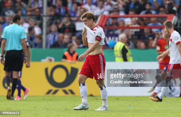 Hamburg's Gotoku Sakai walks off the pitch looking disappointed after the ending of the Cup first-round match between VfL Osnabrueck and Hamburger SV...