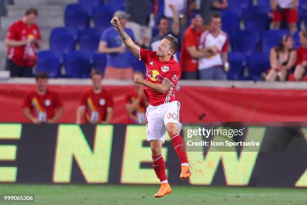 New York Red Bulls midfielder Marc Rzatkowski celebrates after scoring during the second half of the Major League Soccer game between Sporting Kansas...