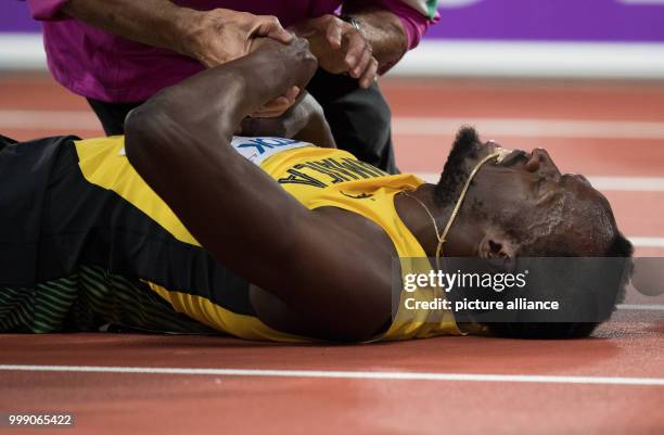 Sprinter Usain Bolt of Jamaica can be seen at the final race of the 4 x 100 metres relay at the IAAF London 2017 World Athletics Championships in...