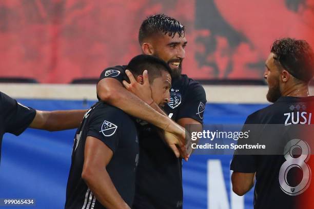 Sporting Kansas City midfielder Roger Espinoza celebrates with teammates after scoring during the second half of the Major League Soccer game between...