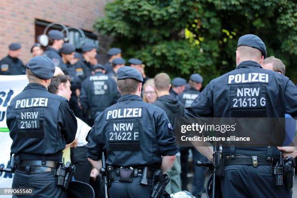 Police officers safeguard the venue of the German party Alternative fuer Deutschland against numerous protestors in Duesseldorf, Germany, 13 August...