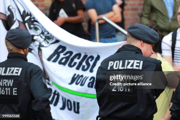 Police officers safeguard the venue of the German party Alternative fuer Deutschland against numerous protestors in Duesseldorf, Germany, 13 August...
