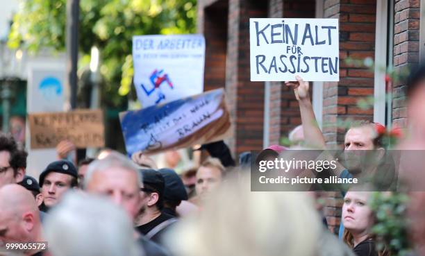 Protestor holds up a sign saying 'Kein Alt für Rassisten' in Duesseldorf, Germany, 13 August 2017. Because of security concers several breweries and...