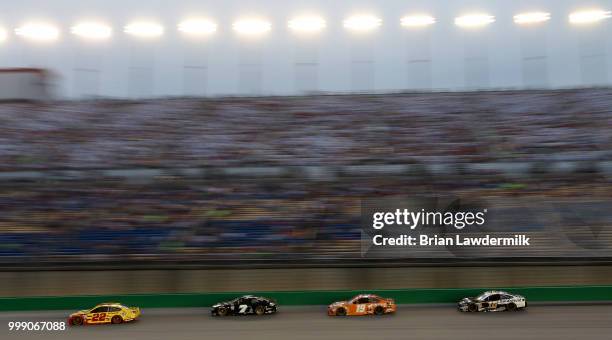 Joey Logano, driver of the Shell Pennzoil Ford, leads a pack of cars during the Monster Energy NASCAR Cup Series Quaker State 400 presented by...