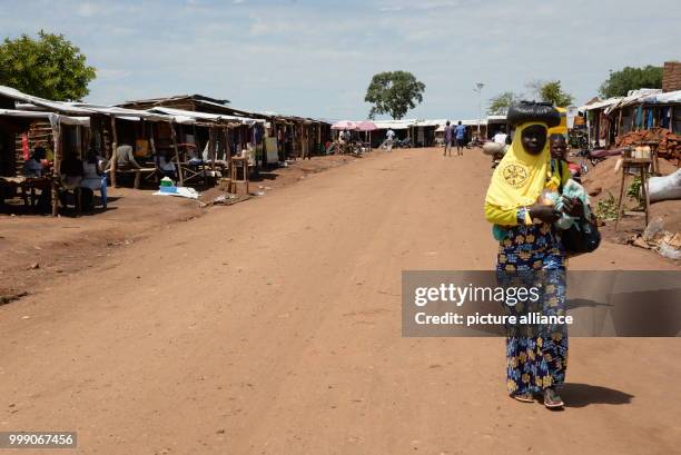 Women walking in a market place in the Bidi Bidi refugee settlement in northwestern Uganda, 28 June 2017. Uganda is praised throughout the world: the...