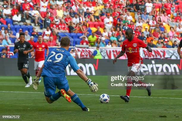New York Red Bulls forward Bradley Wright-Phillips controls the ball past Sporting Kansas City goalkeeper Tim Melia and scores during the first half...