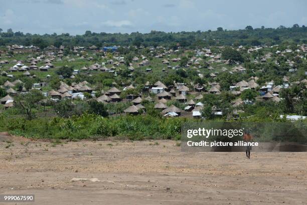 Children walking along a road in the Bidi Bidi refugee settlement in northwestern Uganda, 28 June 2017. Uganda is praised throughout the world: the...