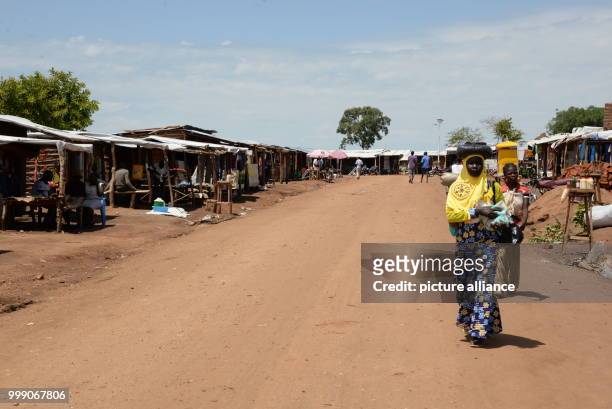 Women walking in a market place in the Bidi Bidi refugee settlement in northwestern Uganda, 28 June 2017. Uganda is praised throughout the world: the...