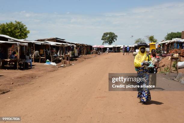 Women walking in a market place in the Bidi Bidi refugee settlement in northwestern Uganda, 28 June 2017. Uganda is praised throughout the world: the...
