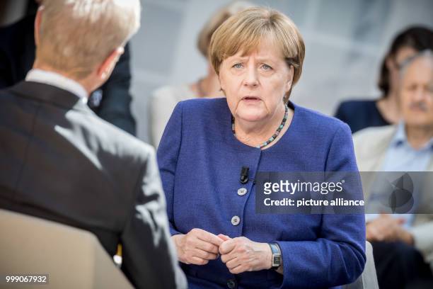 German Chancellor Angela Merkel speaking with journalist Michael Hirz during the recording of the TV program "Forum Politik" of the Phonix...