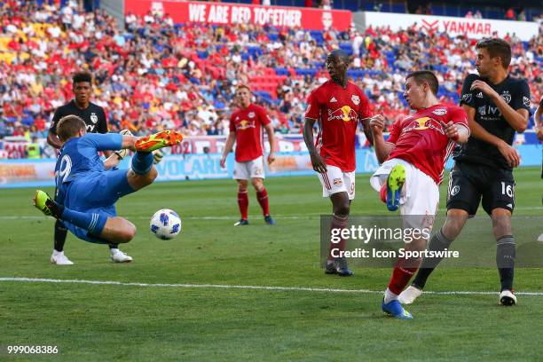 Sporting Kansas City goalkeeper Tim Melia makes a diving save off the flick from New York Red Bulls midfielder Alex Muyl during the first half of the...