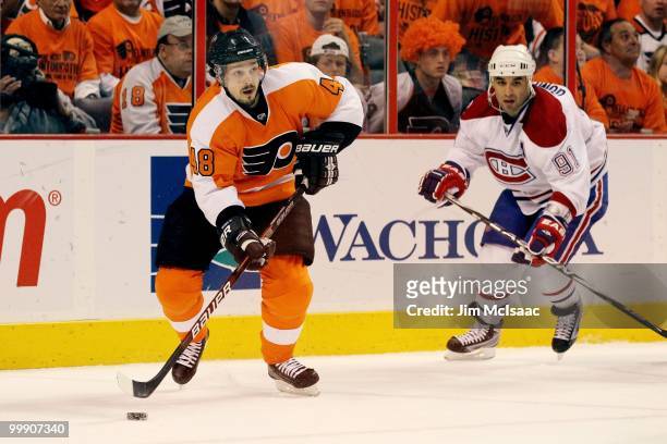 Danny Briere of the Philadelphia Flyers handles the puck against Scott Gomez of the Montreal Canadiens in Game 1 of the Eastern Conference Finals...