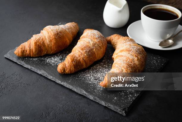 croissants and coffee on black background - close up bread roll black backdrop horizontal stock pictures, royalty-free photos & images