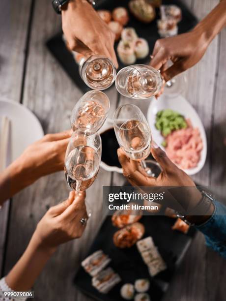 celebrate everything that brings you joy - friends toasting above table stock pictures, royalty-free photos & images