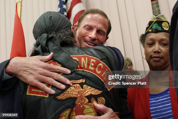 Democratic senatorial candidate, Attorney General of Connecticut Richard Blumenthal hugs a former U.S. Marine after holding a press conference to...