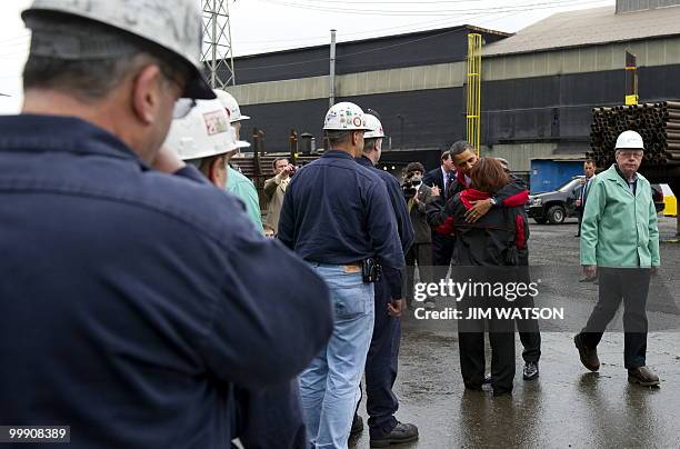 President Barack Obama hugs a woman as he tours through V & M Star, a leading producer of seamless pipe for the oil and gas industry, in Youngstown,...