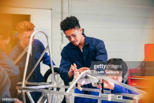 working on an engineering group project - apprentice uk stock pictures, royalty-free photos & images