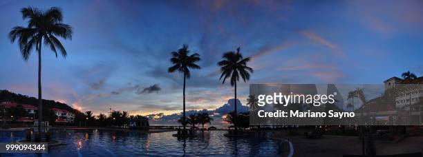 tropical resort with pool during sunset - mariano stock pictures, royalty-free photos & images