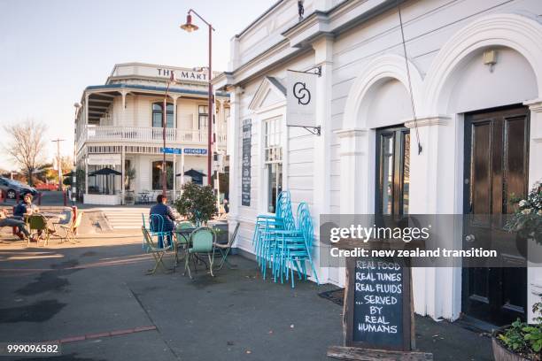cafe at corner of kitchener st in martinborough village with historic hotel in background in late afternoon light, wairarapa - late afternoon stock pictures, royalty-free photos & images