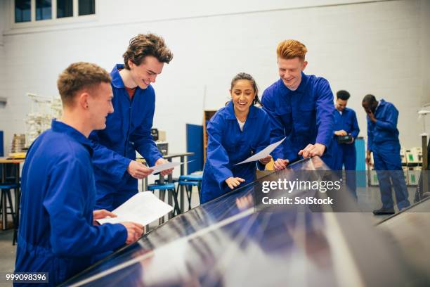 working on an engineering group project - it apprentice stock pictures, royalty-free photos & images
