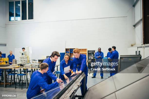 working on an engineering group project - building apprentice stock pictures, royalty-free photos & images