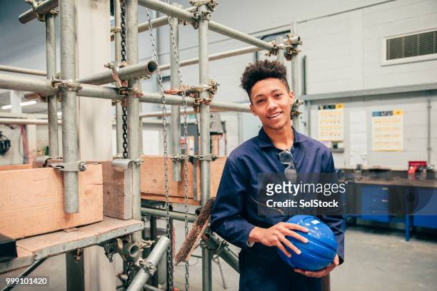 portrait of an engineering student - blue jumpsuit stock pictures, royalty-free photos & images