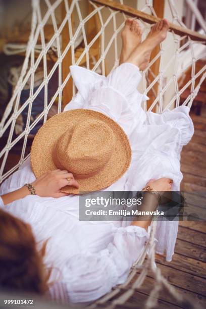 boho girl lying in a summer hammock - emilija manevska stock-fotos und bilder