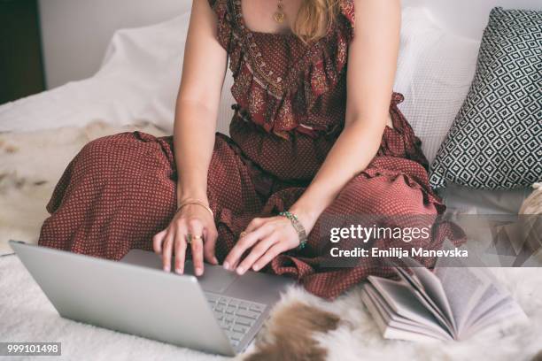 close up of woman using laptop at home - emilija manevska stock-fotos und bilder