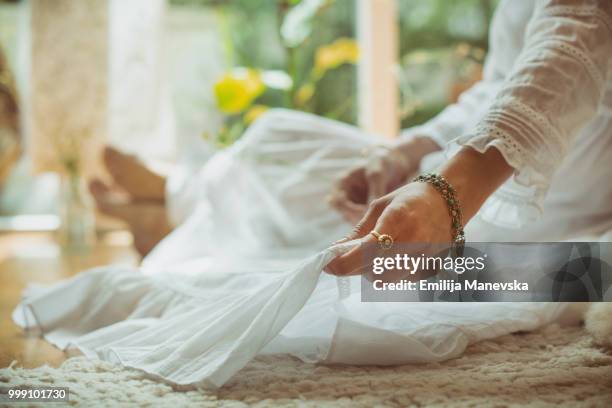 close up of a young woman wearing boho dress - emilija manevska stock-fotos und bilder