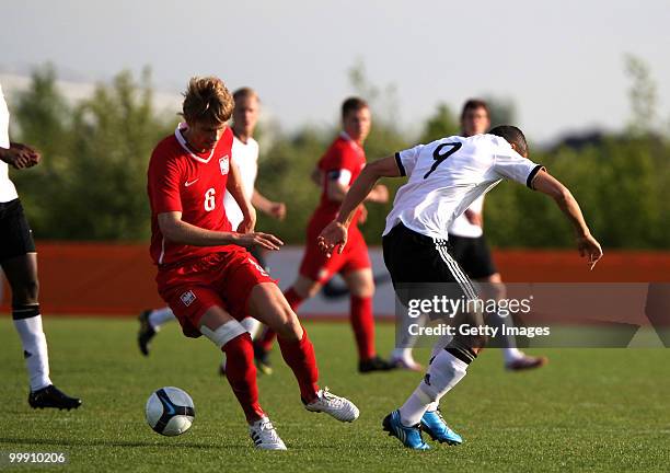 Cenk Tosun of Germany battles for the ball with Bartoz Salamon of Poland during the U19 Championship Elite Round match between Germany and Poland at...