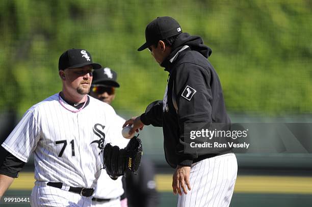 Manager Ozzie Guillen gives the baseball to Scott Linebrink the Chicago White Sox during a pitching change against the Toronto Blue Jays on May 9,...