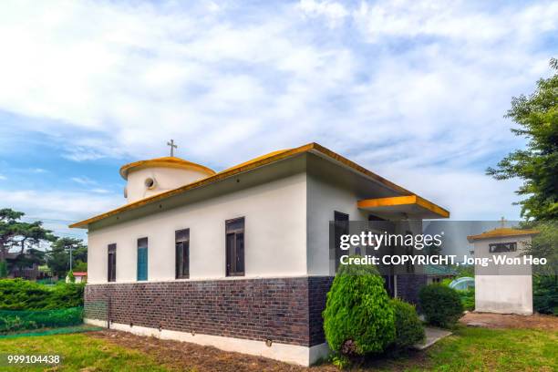 a cute yellow roof church - jong won heo stock-fotos und bilder