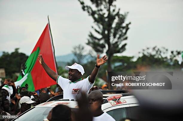 Burundi's Nkurunziza on God and grassroots development** Burundian President Pierre Nkurunziza waves to a crowd of supporters at the end of a...