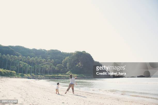 madre e figlio che giocano in spiaggia - kohei hara foto e immagini stock