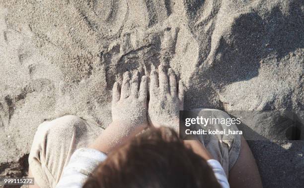 jongen spelen in het strand - kohei hara stockfoto's en -beelden