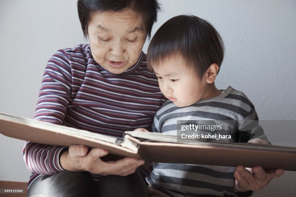 Grandmother and grandson looking a photo album together