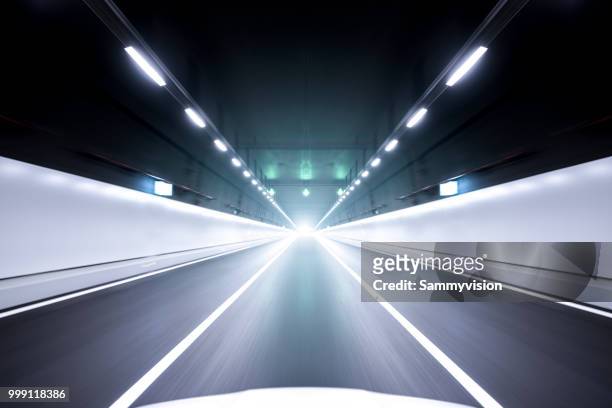 speeding in the tunnel - multiple lane highway ストックフォトと画像