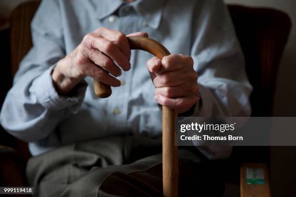 old man, male hand gripping a walking stick, nursing home, retirement home, berlin, germany - lonely senior citizen stock pictures, royalty-free photos & images