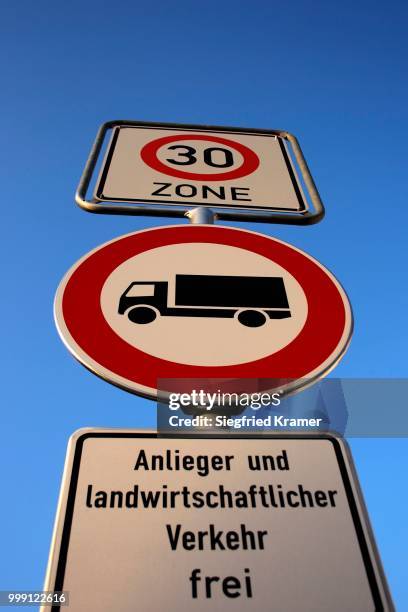 traffic signs, 30 zone, truck/lorry ban, residents and agricultural traffic excluded - winkelwagen stock-fotos und bilder