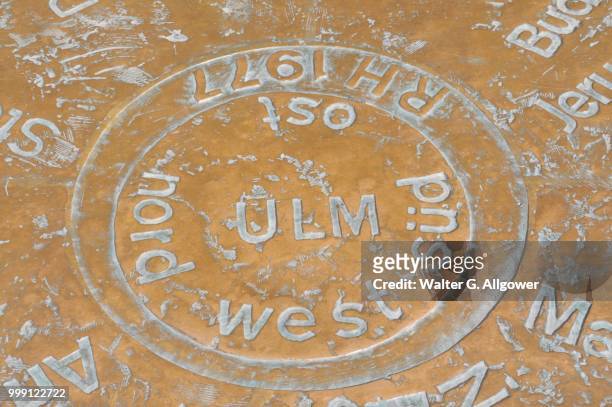 in muensterplatz square a copper plate shows the distances to other towns, ulm, baden-wuerttemberg, germany - square plate stock pictures, royalty-free photos & images
