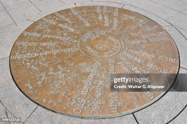 in muensterplatz square a copper plate shows the distances to other towns, ulm, baden-wuerttemberg, germany - square plate stock pictures, royalty-free photos & images