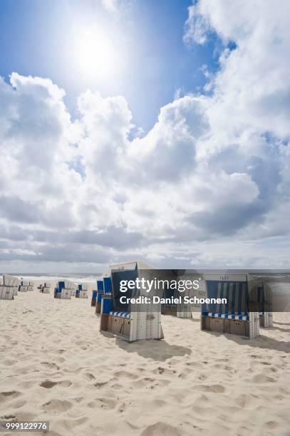 roofed wicker beach chairs on the beach in westerland, sylt island, schleswig-holstein, germany - contre jour stock-fotos und bilder