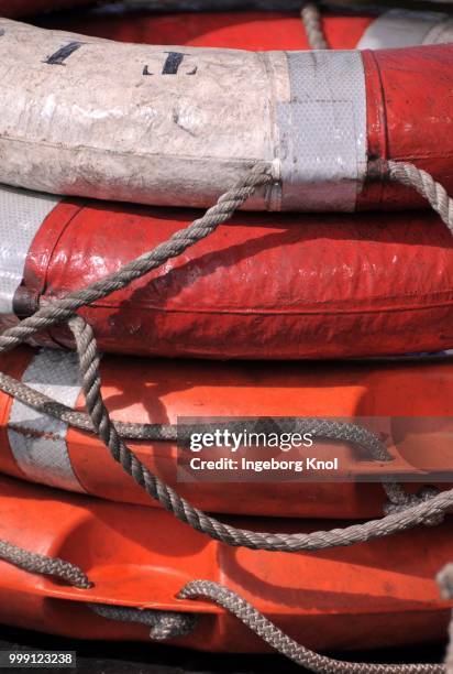 stack of lifebuoys - balustrade stock photos et images de collection