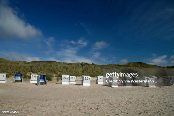 dunes and roofed wicker beach chairs, sylt, northern friesland, north frisia, schleswig-holstein, germany - touristical stock pictures, royalty-free photos & images