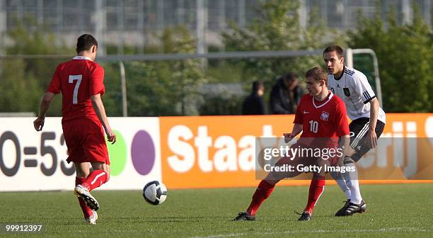 Sören Bertram of Germany battles for the ball with Marco Stiepermann and Adrian Blad of Poland during the U19 Championship Elite Round match between...