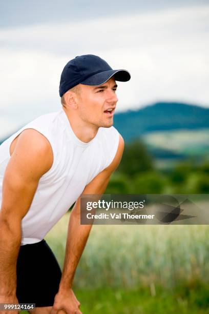 jogger taking a break, fields near coburg, bavaria, germany - coburg stock pictures, royalty-free photos & images