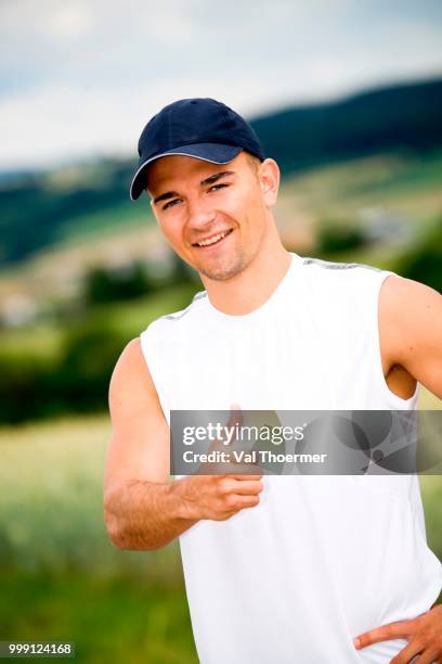 athletic young man showing thumbs up, fields near coburg, bavaria, germany - coburg stock pictures, royalty-free photos & images